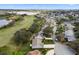 Residential homes on a street with green lawns in a community near a golf course and pond at 4826 Summerbridge Cir, Leesburg, FL 34748