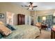 Bright bedroom featuring a ceiling fan, closet, and access to the patio at 4826 Summerbridge Cir, Leesburg, FL 34748