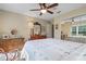 Bedroom featuring a ceiling fan, dresser, and a mirrored closet at 4826 Summerbridge Cir, Leesburg, FL 34748