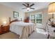 Bedroom featuring a ceiling fan, dresser, and a window with blinds at 4826 Summerbridge Cir, Leesburg, FL 34748