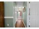 Hallway with hardwood floors leading to a bathroom at 4826 Summerbridge Cir, Leesburg, FL 34748