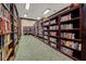 A large library with rows of filled book shelves and a carpeted floor at 4826 Summerbridge Cir, Leesburg, FL 34748