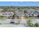 Aerial view of a neighborhood showcasing well-maintained homes, mature trees, and proximity to a park at 4951 Cypress Hammock Dr, St Cloud, FL 34771