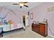 Bedroom with pink walls, carpet, and a large window, leading to a walk-in closet at 4951 Cypress Hammock Dr, St Cloud, FL 34771