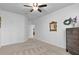 Light-filled bedroom with a neutral color scheme and carpet, features a large window and closet access at 4951 Cypress Hammock Dr, St Cloud, FL 34771