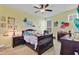 Bright, charming bedroom with a ceiling fan, carpet, and a dark wood bed set at 4951 Cypress Hammock Dr, St Cloud, FL 34771