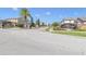 East Lake Park gated community entrance with palm trees and landscaped medians under a sunny, blue sky at 4951 Cypress Hammock Dr, St Cloud, FL 34771