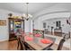 Elegant dining room with hardwood floors, chandelier lighting, and classic wood furniture at 4951 Cypress Hammock Dr, St Cloud, FL 34771