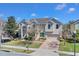 Charming two-story home featuring mature trees, brick driveway, and attached garage at 4951 Cypress Hammock Dr, St Cloud, FL 34771