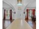 Bright foyer features high ceilings, tile and wood flooring, chandelier lighting, and a decorative front door at 4951 Cypress Hammock Dr, St Cloud, FL 34771