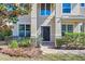 Elegant front entrance with black door, sidelights, and manicured landscaping at 4951 Cypress Hammock Dr, St Cloud, FL 34771