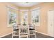 Bright breakfast nook with white wood table and matching chairs and seashell window treatments at 5370 Indian Ocean Loop, Tavares, FL 32778