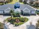 Aerial view of a spacious clubhouse surrounded by beautifully landscaped grounds and palm trees at 5370 Indian Ocean Loop, Tavares, FL 32778