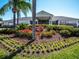 Well-manicured flower beds and shrubbery surrounding the front entrance of this large clubhouse at 5370 Indian Ocean Loop, Tavares, FL 32778