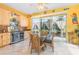 Bright dining nook with light wood cabinets, wet bar, a glass table and wicker chairs; all adjacent to outdoor patio at 5370 Indian Ocean Loop, Tavares, FL 32778