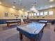 Bright, spacious game room with multiple covered billiards tables for residents' enjoyment at 5370 Indian Ocean Loop, Tavares, FL 32778