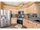 Well-lit kitchen featuring stainless steel appliances and tiled backsplash at 5370 Indian Ocean Loop, Tavares, FL 32778