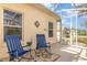 Covered patio with rocking chairs, perfect for enjoying the beautiful weather at 5370 Indian Ocean Loop, Tavares, FL 32778