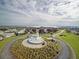 Aerial view of lighthouse landmark on lush point surrounded by homes and waterway at 5370 Indian Ocean Loop, Tavares, FL 32778