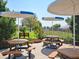 Shaded outdoor picnic tables under large umbrellas in a lush setting at 5370 Indian Ocean Loop, Tavares, FL 32778