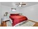 Bright bedroom features a ceiling fan, comfortable bed, and light-colored walls, creating a relaxing atmosphere at 54 Pecan Pass, Ocala, FL 34472