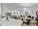 Open dining room with chandelier flowing to the living room and kitchen at 54 Pecan Pass, Ocala, FL 34472