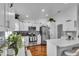 Well-lit kitchen featuring white cabinets, stainless steel appliances, modern backsplash, and hardwood floors at 54 Pecan Pass, Ocala, FL 34472