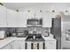 Modern kitchen featuring stainless steel microwave, range, and refrigerator at 54 Pecan Pass, Ocala, FL 34472