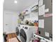 Laundry room featuring modern washer and dryer, shelving, and storage at 54 Pecan Pass, Ocala, FL 34472