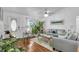 Cozy living room featuring hardwood floors, a ceiling fan, and lots of plants at 54 Pecan Pass, Ocala, FL 34472