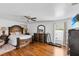 Spacious main bedroom featuring a ceiling fan, wood floors, and large windows for natural light at 54 Pecan Pass, Ocala, FL 34472