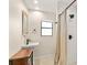 Bathroom with walk-in shower, vanity sink, white subway tiles and beige hexagon tile floors at 580 Page Ln, Mount Dora, FL 32757