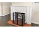 Close-up of the living room fireplace with white brick surround and protective metal screen at 580 Page Ln, Mount Dora, FL 32757