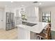 Modern kitchen featuring white cabinetry, stainless steel appliances, and a breakfast bar at 580 Page Ln, Mount Dora, FL 32757