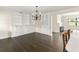 Open living room with dark wood floors, built in shelves, decorative chandelier and open floor plan at 580 Page Ln, Mount Dora, FL 32757