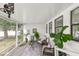 Relaxing screened porch with comfortable seating and lots of plants at 580 Page Ln, Mount Dora, FL 32757