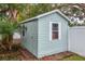 Backyard shed featuring white trim, horizontal siding, single door entry, and small window for natural light at 580 Page Ln, Mount Dora, FL 32757