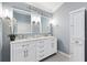 Modern bathroom with double vanity, marble countertop, and decorative fixtures at 589 Sherwood St, The Villages, FL 32162