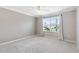 Bright, empty bedroom with a large window that lets in plenty of natural light at 589 Sherwood St, The Villages, FL 32162