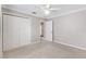 Neutral bedroom featuring carpet, a ceiling fan, and a closet at 589 Sherwood St, The Villages, FL 32162