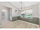 Charming dining area with natural light, wainscoting detail, and modern chandelier at 589 Sherwood St, The Villages, FL 32162