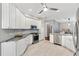 Spacious kitchen showcasing white cabinetry, stainless steel appliances, and tile backsplash, offering a modern cooking space at 589 Sherwood St, The Villages, FL 32162