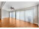 Bright living room featuring hardwood floors and sliding glass doors for ample natural light at 589 Sherwood St, The Villages, FL 32162