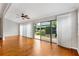 Bright living area with hardwood floors and sliding glass doors offering a view of the backyard at 589 Sherwood St, The Villages, FL 32162