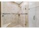 Elegant shower with glass doors and decorative tile, with seat included at 589 Sherwood St, The Villages, FL 32162