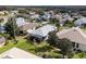 Overhead view of the neighborhood, featuring mature trees and green lawns at 5952 Brittania Blvd, Tavares, FL 32778