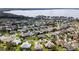 Aerial view of the community homes surrounding a lake, with lush greenery and well-maintained landscaping at 5952 Brittania Blvd, Tavares, FL 32778