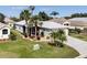 An aerial view of a well-maintained home showcasing a nicely manicured lawn and paved driveway at 5952 Brittania Blvd, Tavares, FL 32778