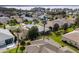 Aerial view of the community, featuring mature trees and green lawns at 5952 Brittania Blvd, Tavares, FL 32778