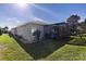 Expansive backyard featuring a screened-in porch perfect for outdoor seating and relaxation at 5952 Brittania Blvd, Tavares, FL 32778